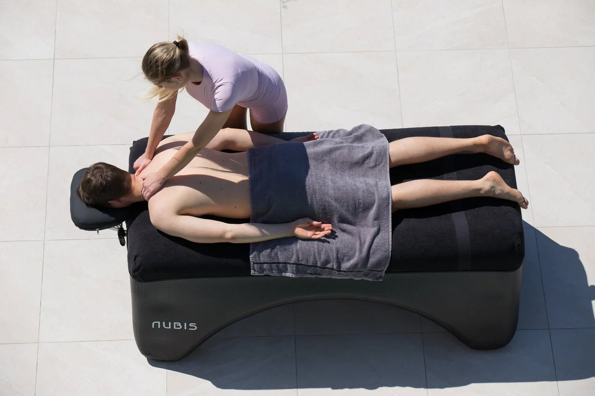 Therapist treating an athlete on a Nubis portable table