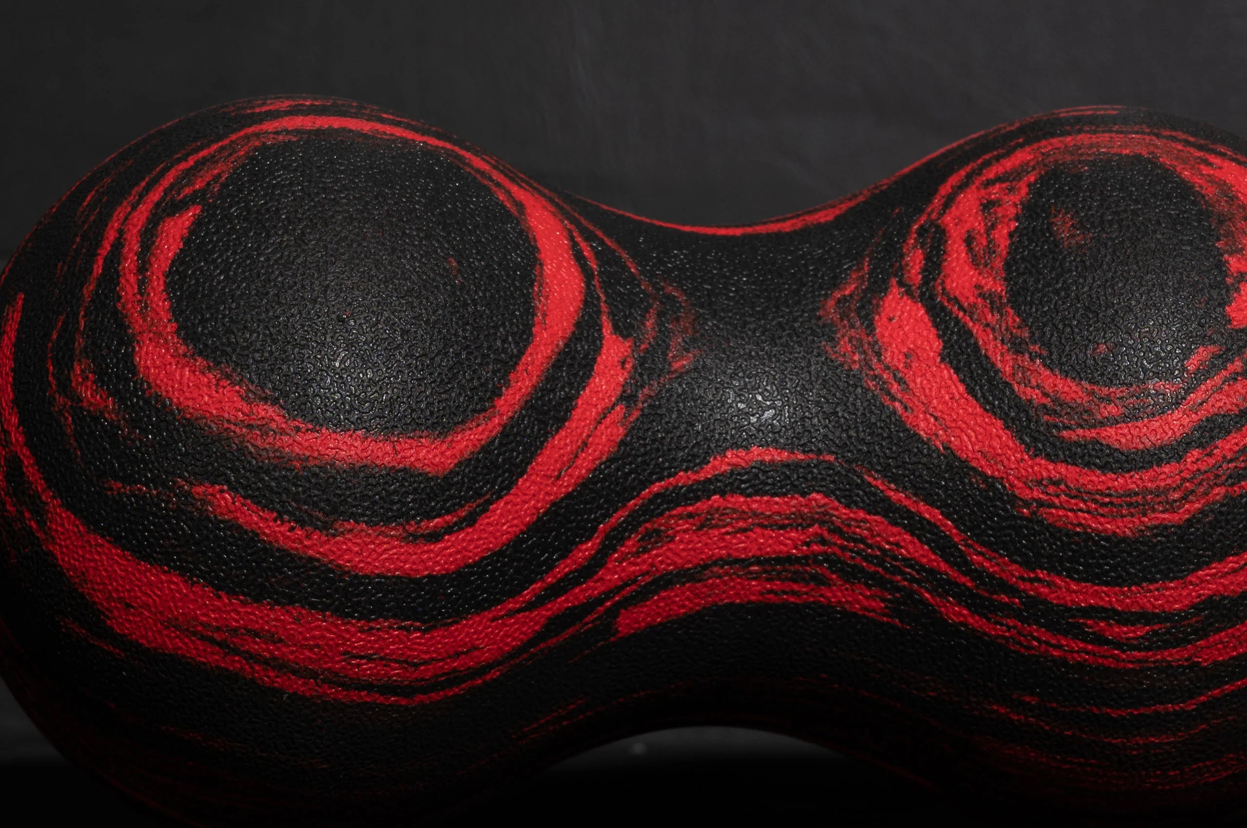 Roller-Peanut-Foam-COREFX Red and black marbled object on a white background Black and red abstract design on a textured surface